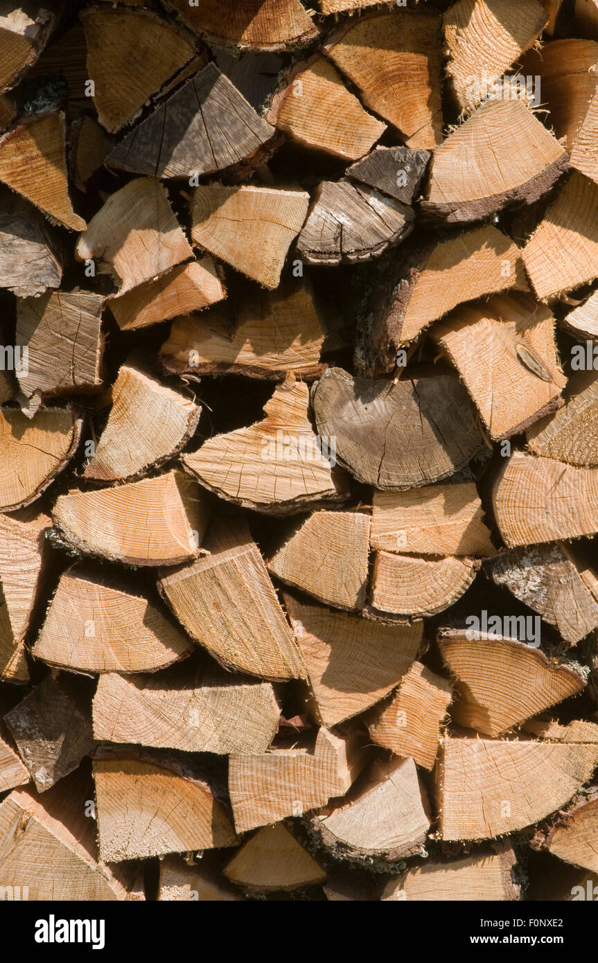 chopped fire wood firewood chopping cutting stacked stacking split branches dry drying seasoning for the winter store stored car Stock Photo