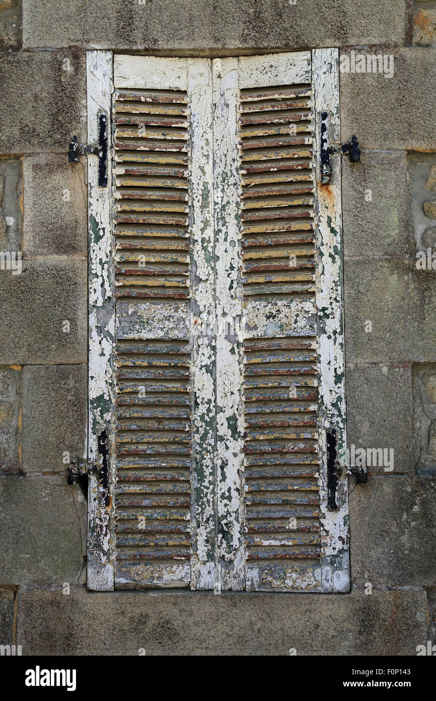 White wooden shutters closed with peeling paint in Gr Grande Rue, Ile d ...