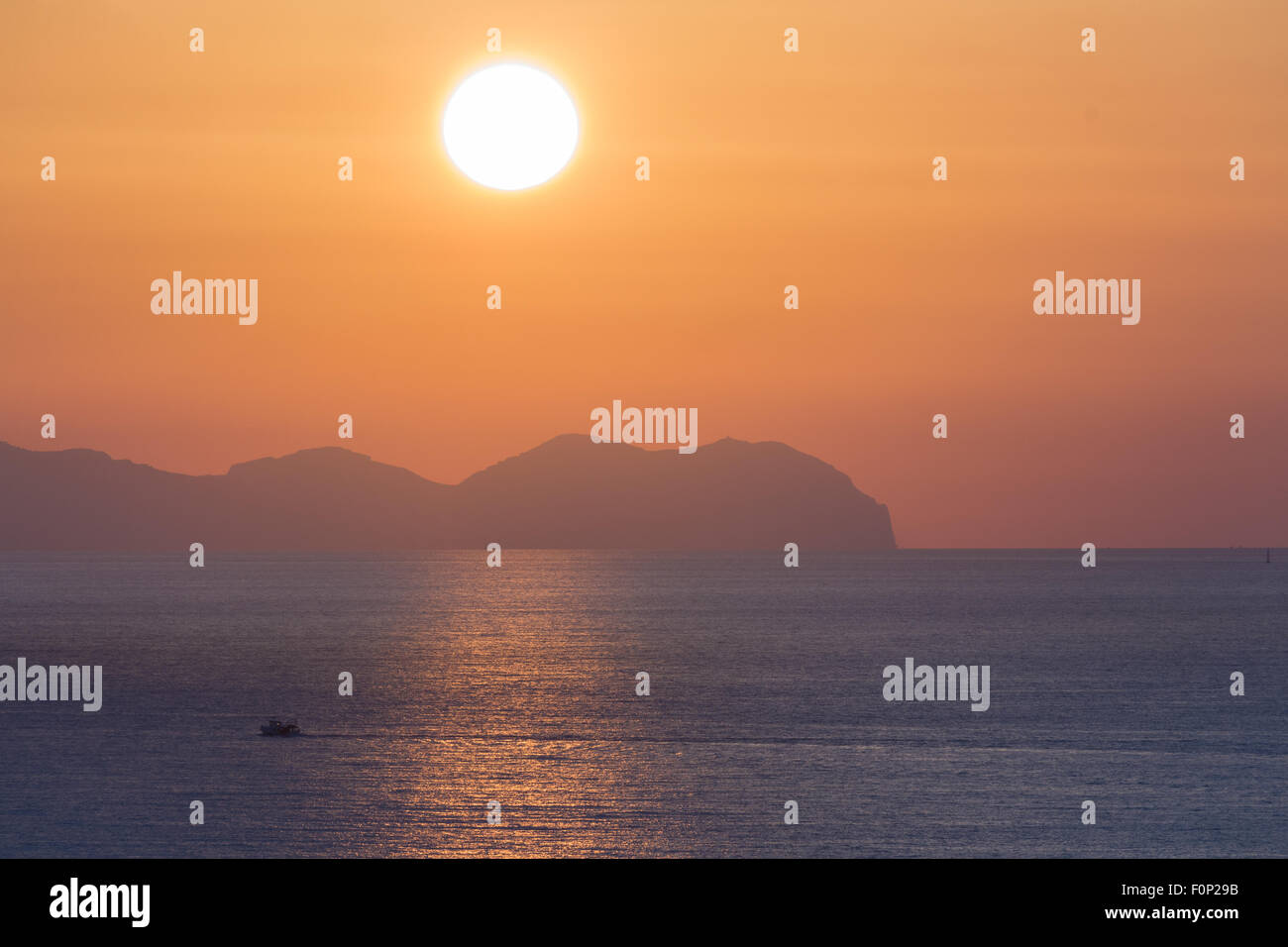 Sunset at sea with shipping boat silhouette Stock Photo - Alamy
