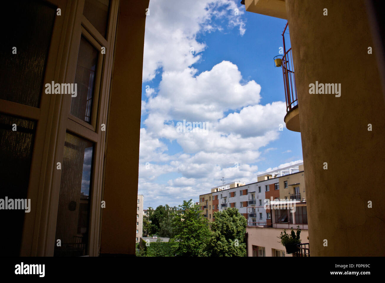 blue sky with white clouds between residential buildings Stock Photo ...