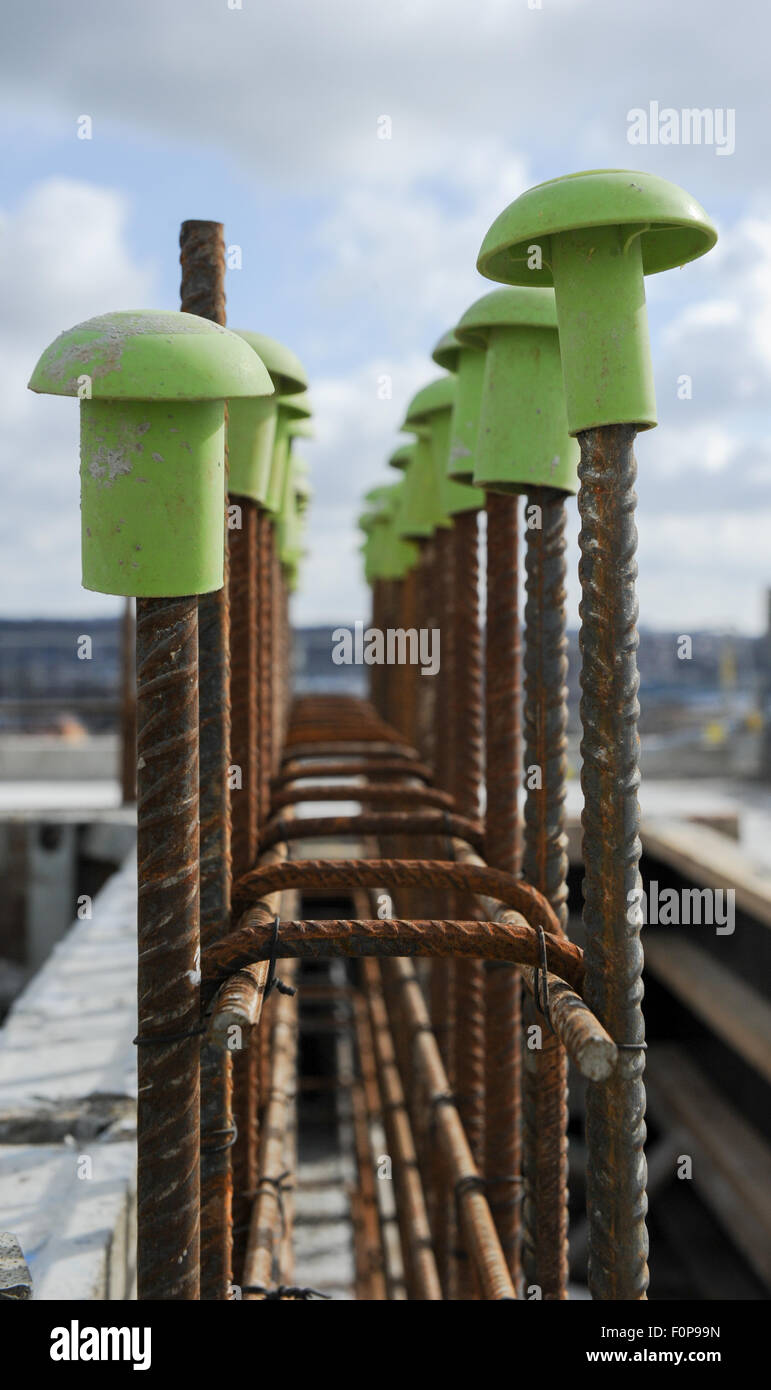 Plastic Rebar Caps on building sites to protect from sharp metal work Stock Photo