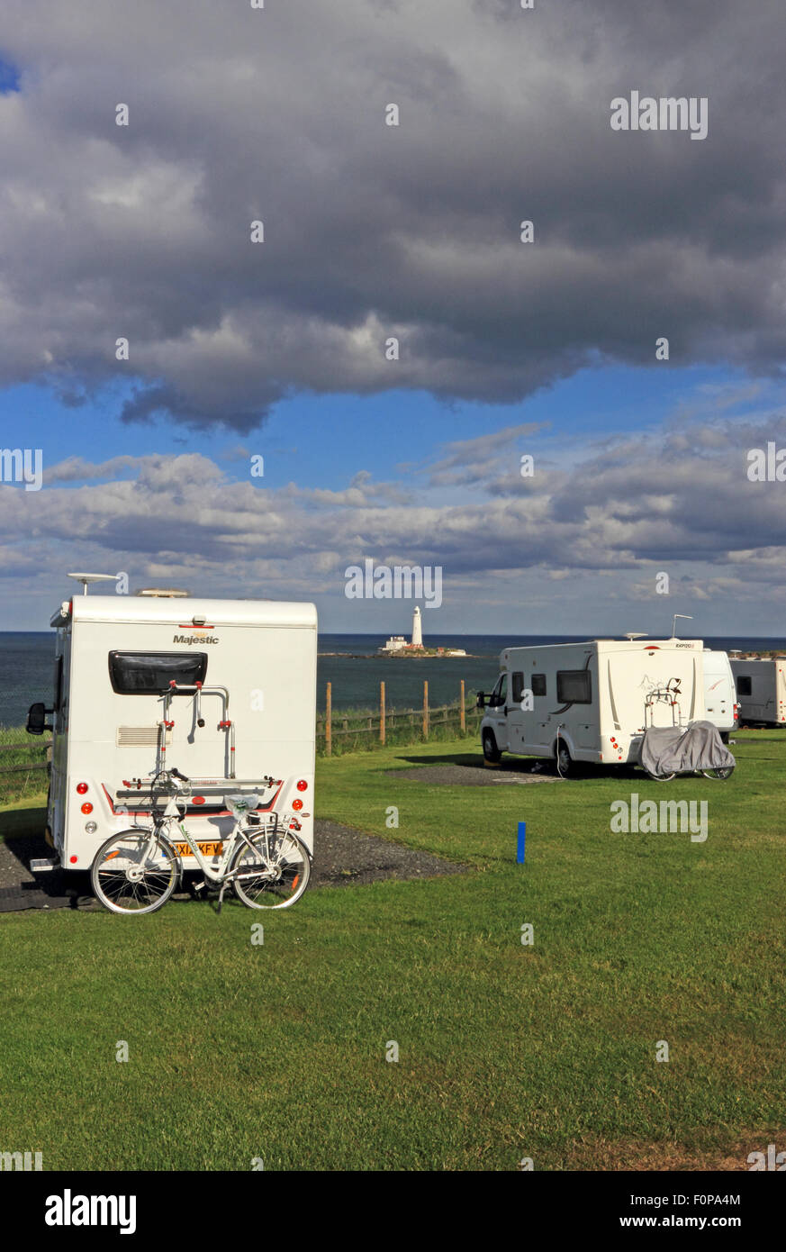 Old Hartley Caravan Club site, with St. Mary's lighthouse in distance Stock Photo