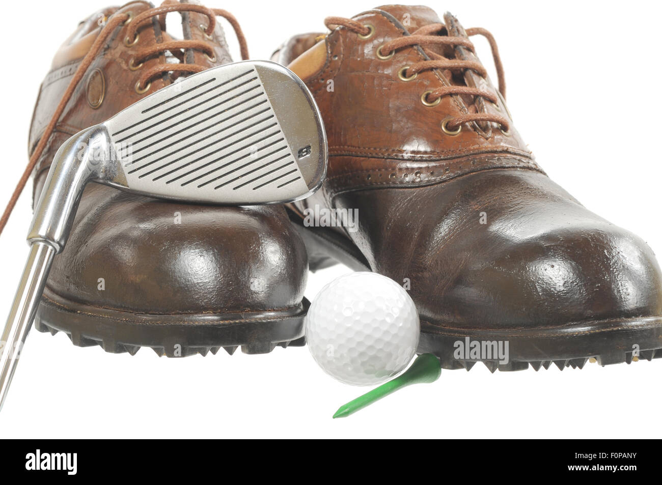 Golf shoes with iron and ball on white Stock Photo