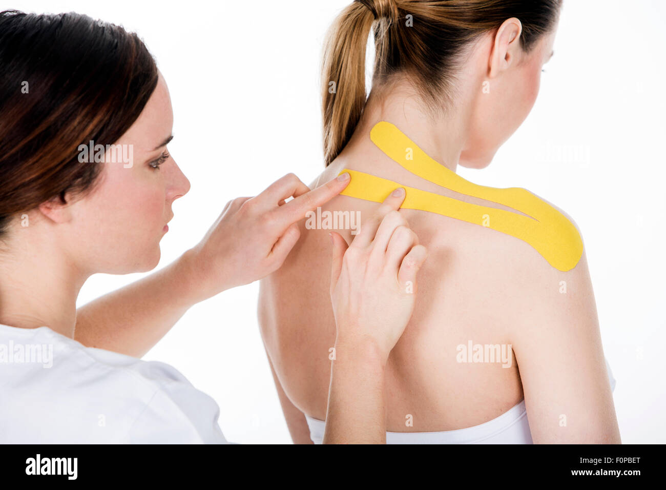 physiotherapist who gets taping on the trapezius Stock Photo