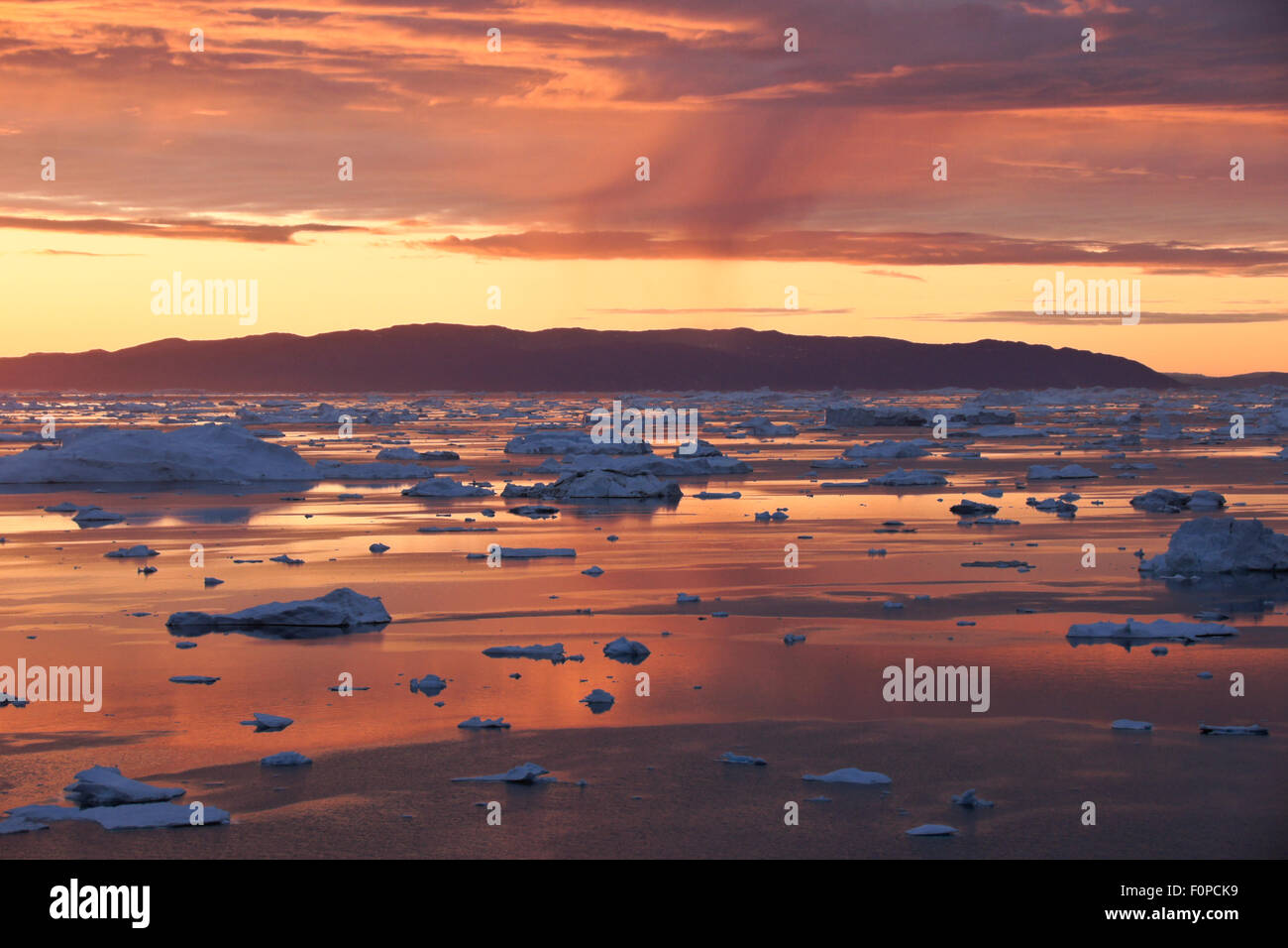 Midnight Sun and icebergs in Disko Bay, Ilulissat, West Greenland Stock Photo