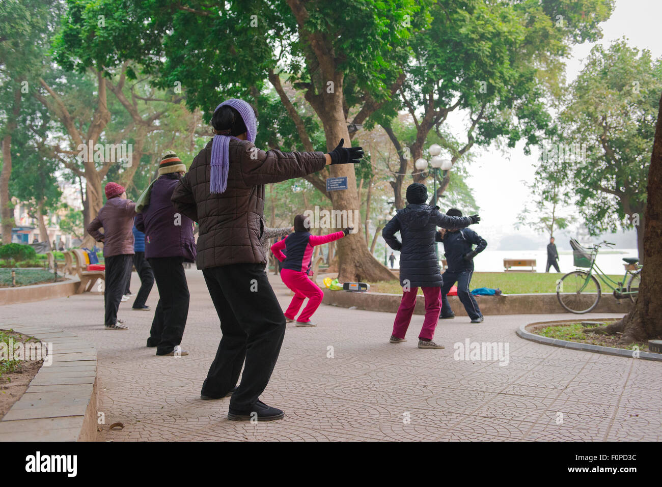 Hanoi tai chi, view of a group of middle aged women participating in an early morning tai chi session beside Hoan Kiem Lake Hanoi, Vietnam. Stock Photo