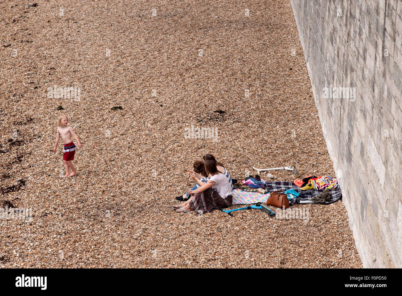 young people enjoy a day on an empty beach at the hot walls old portsmouth england uk Stock Photo