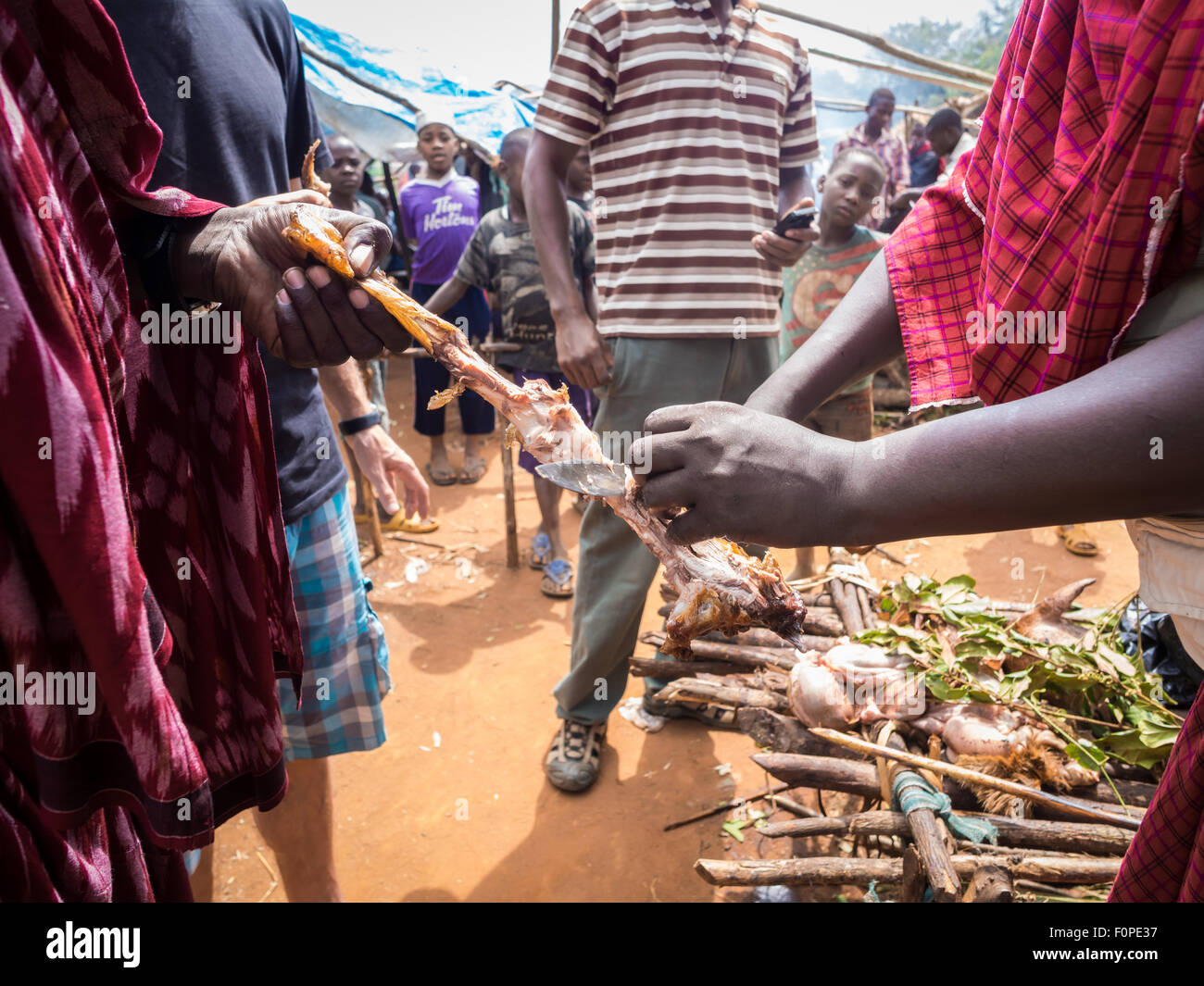 Nyama choma, grilled red meat prepared in traditional way eaten by men