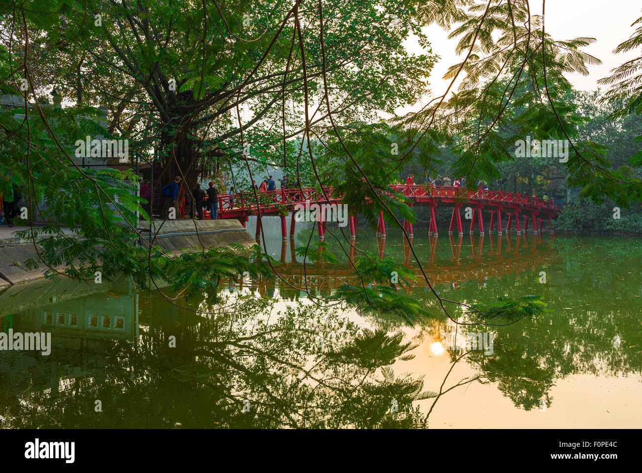 Huc Bridge Hanoi, view of tourists crossing the Huc Bridge on Hoan Kiem Lake in to visit the Temple Of The Jade Mound, Hanoi, Vietnam. Stock Photo