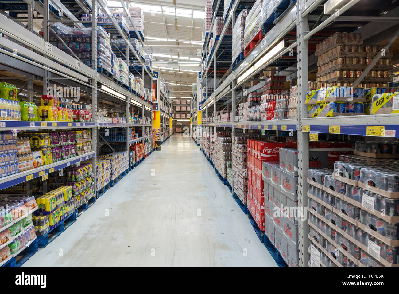 Products on shelving on an aisle in a cash and carry store interior