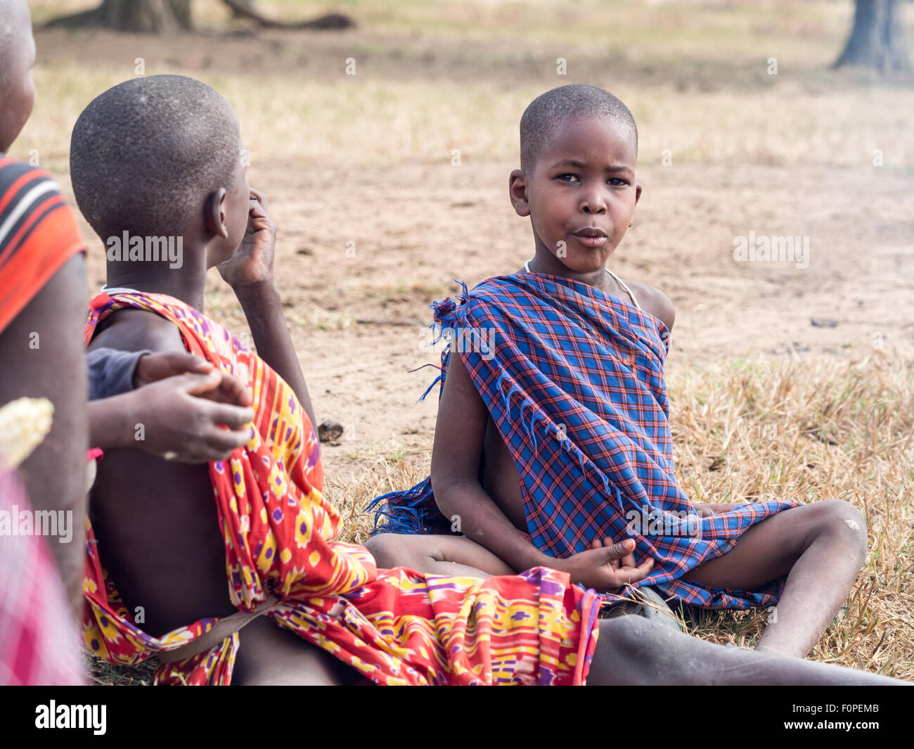Maasain children sitting next to a fire in their boma (village) in Tanzania, Africa. Stock Photo