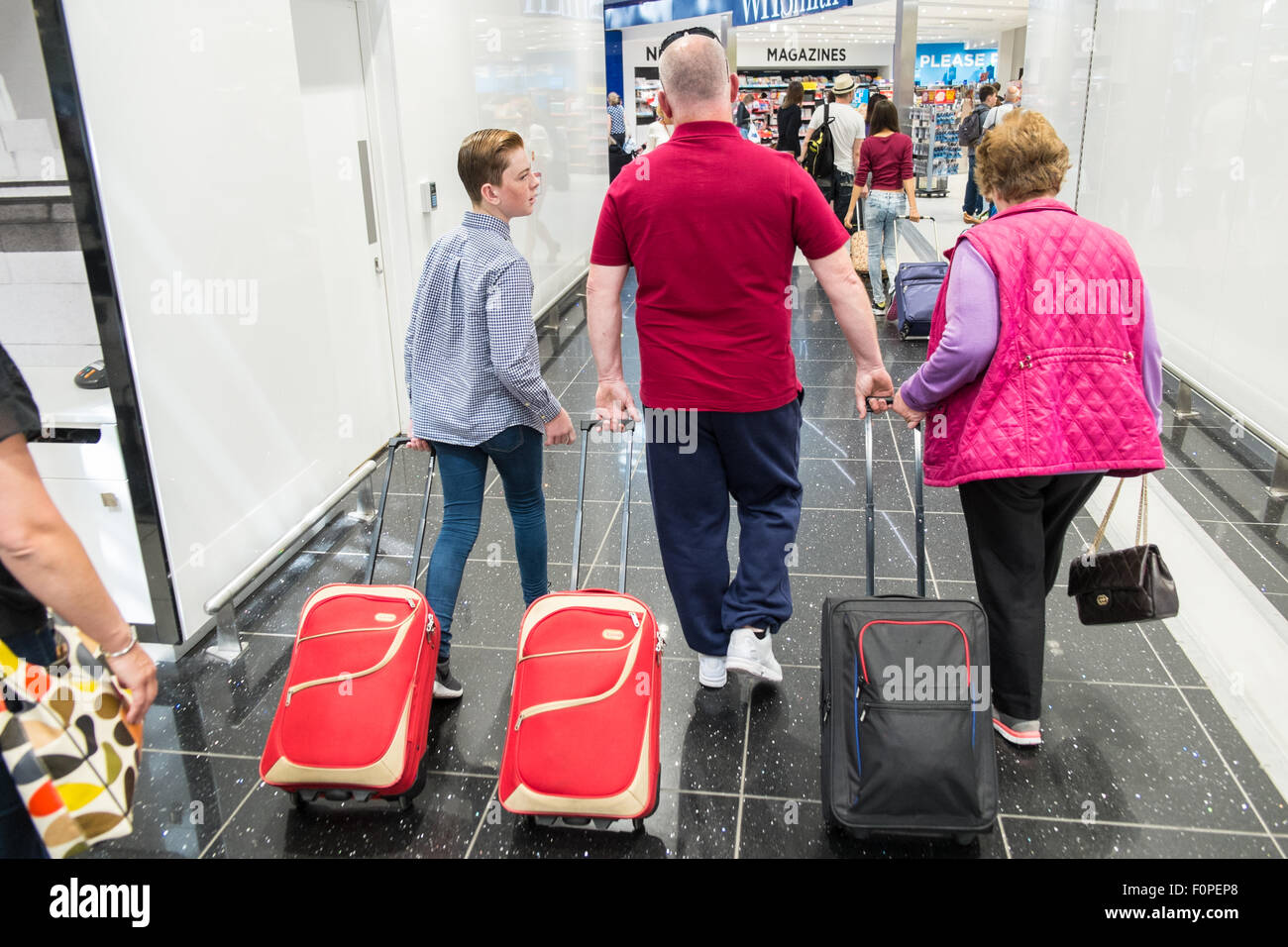 Passengers,travellers with luggage and shops,currency exchange outlets at Departures Terminal at Stansted Airport,London,U.K. Stock Photo
