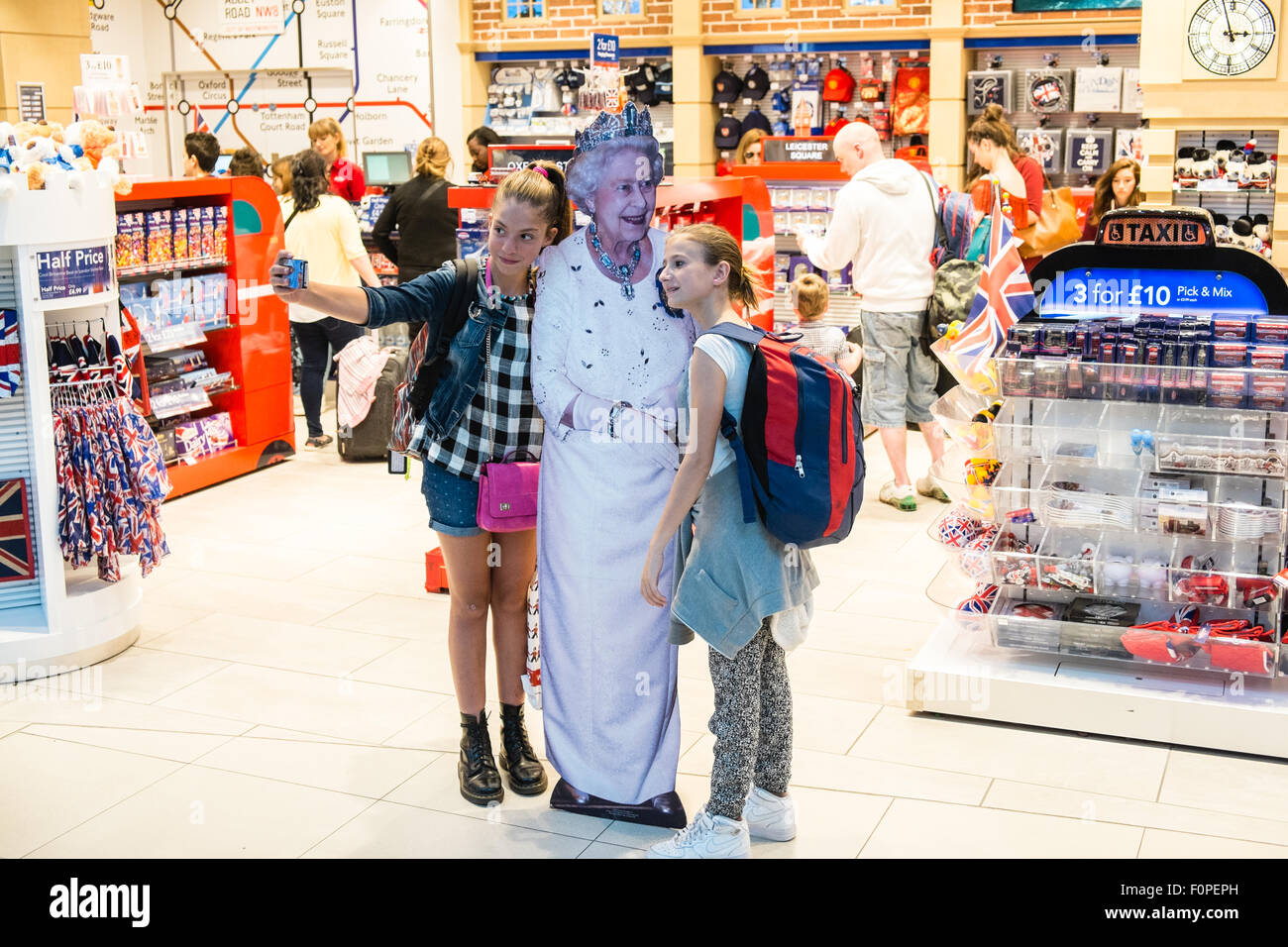 funny,royalty,The, Queen, greets, tourists, at tourist shop outlet 'Glorious Britain' gift shop. Departures Terminal, Stansted Airport,London,U.K. Stock Photo