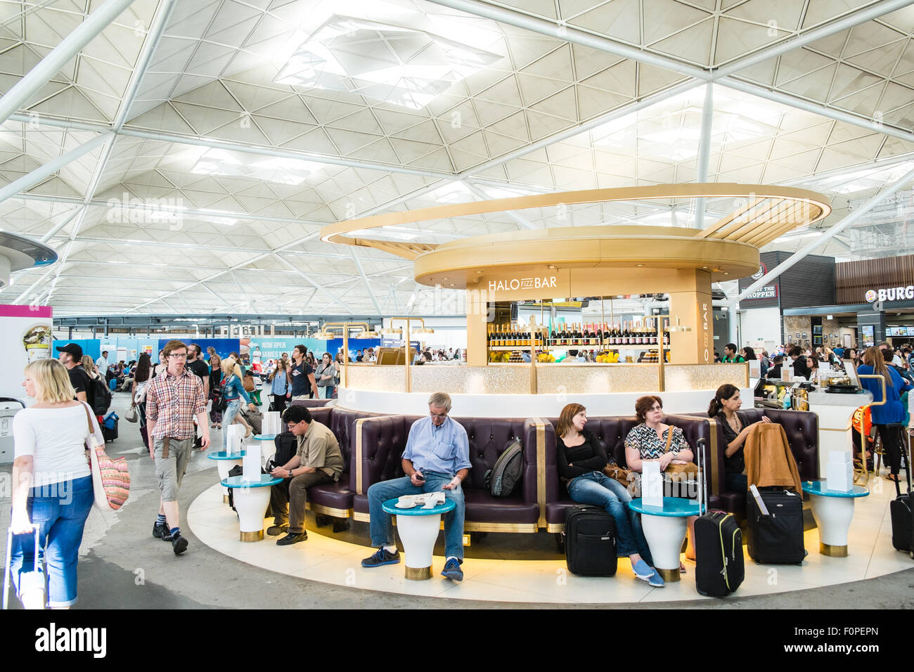 Passengers,travellers with luggage and shops,currency exchange outlets at Departures Terminal at Stansted Airport,London,U.K. Stock Photo