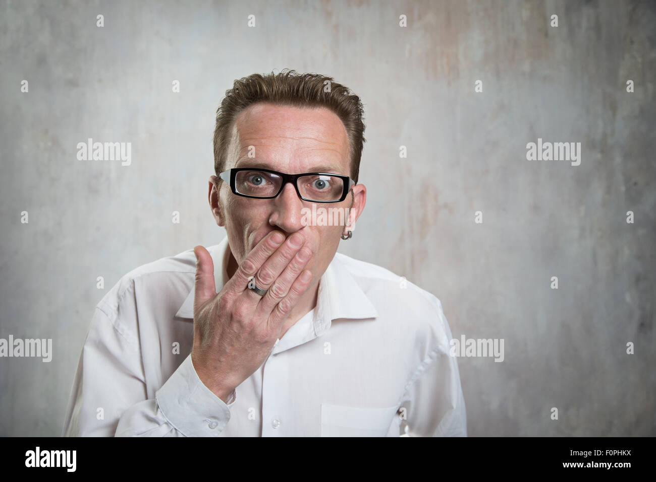 man close his mouth by hand. Concept of suppression Stock Photo