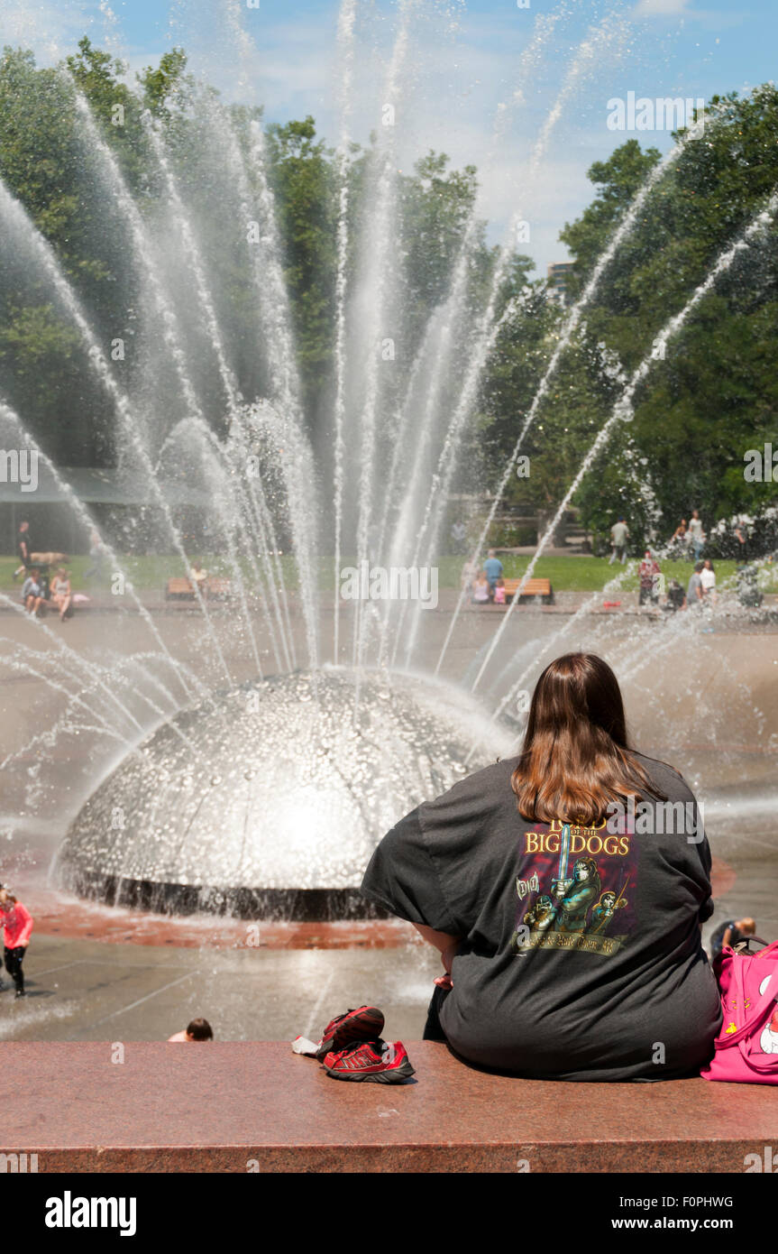 Woman watching the International Fountain at the Seattle Center. Stock Photo