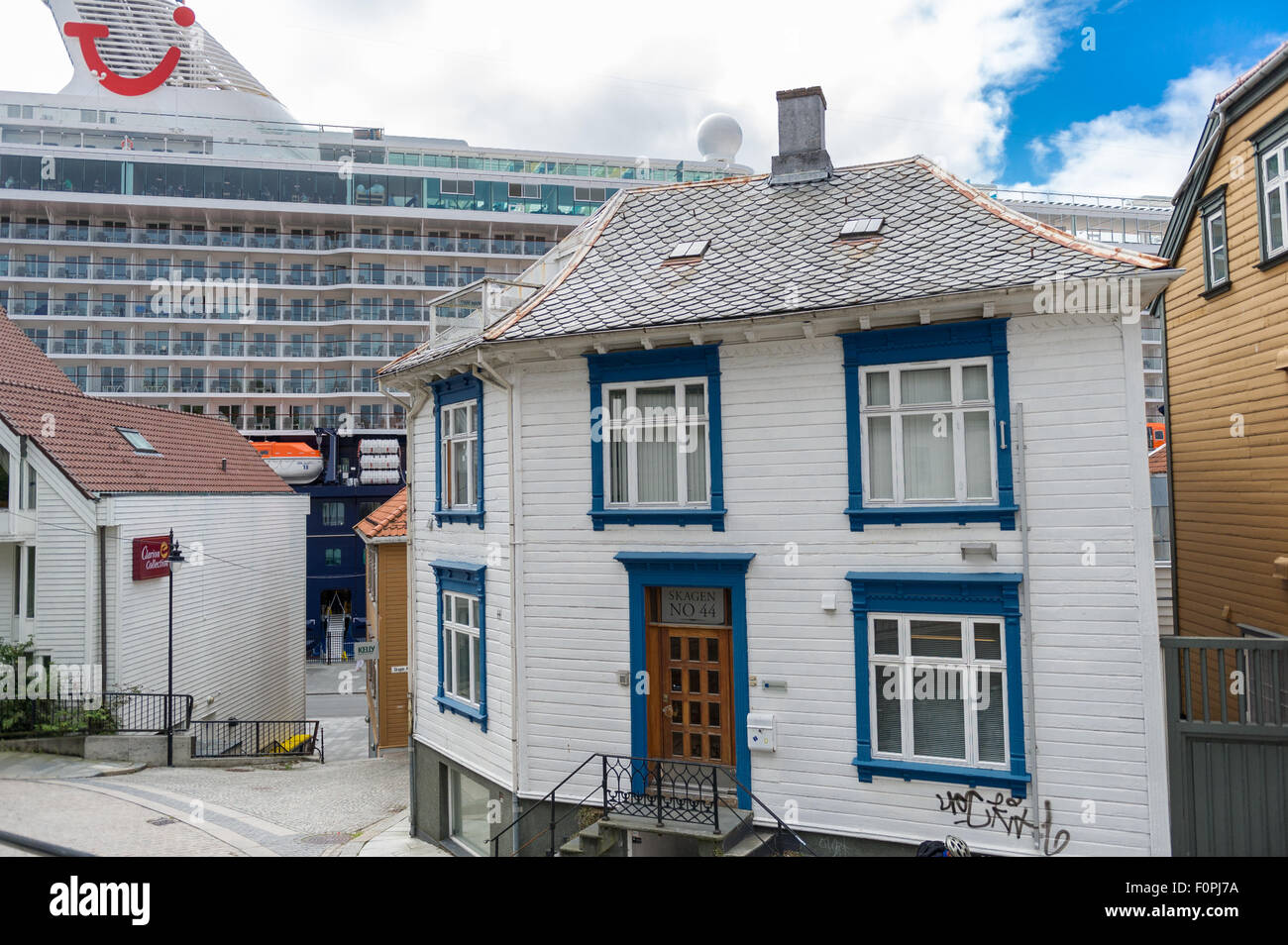 TUI cruise ship Mein Schiff in port of Stavanger, Norway and traditional wood paneled houses. Stock Photo