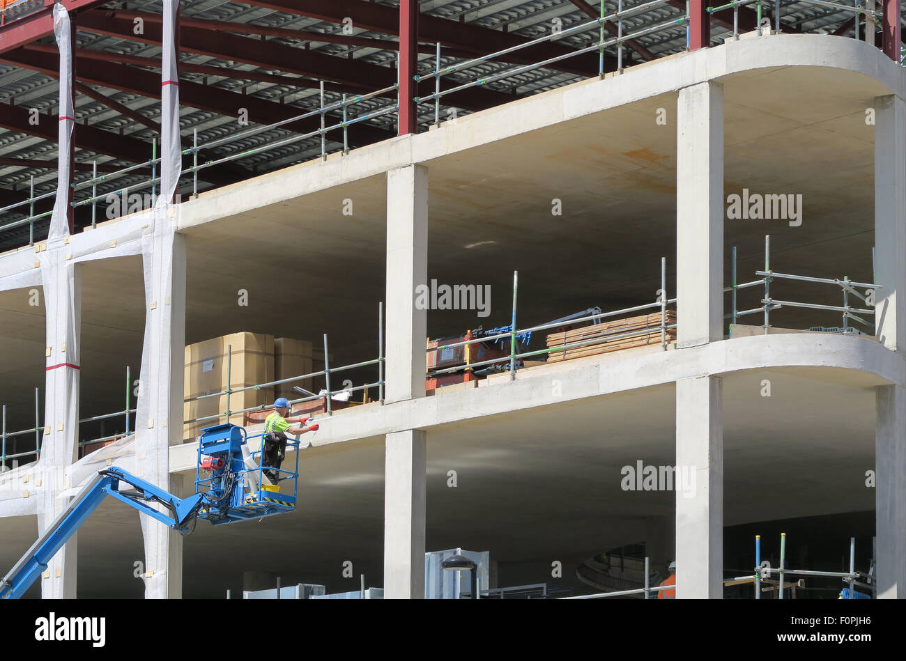 Construction worker using platform picker on new build Stock Photo Alamy
