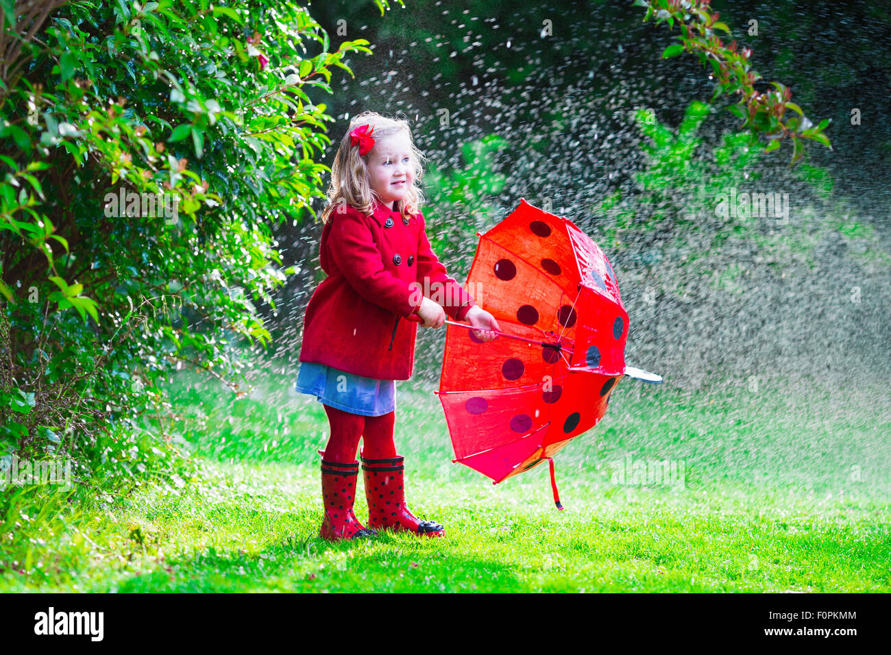 Kids playing in rain hi-res stock photography and images - Alamy
