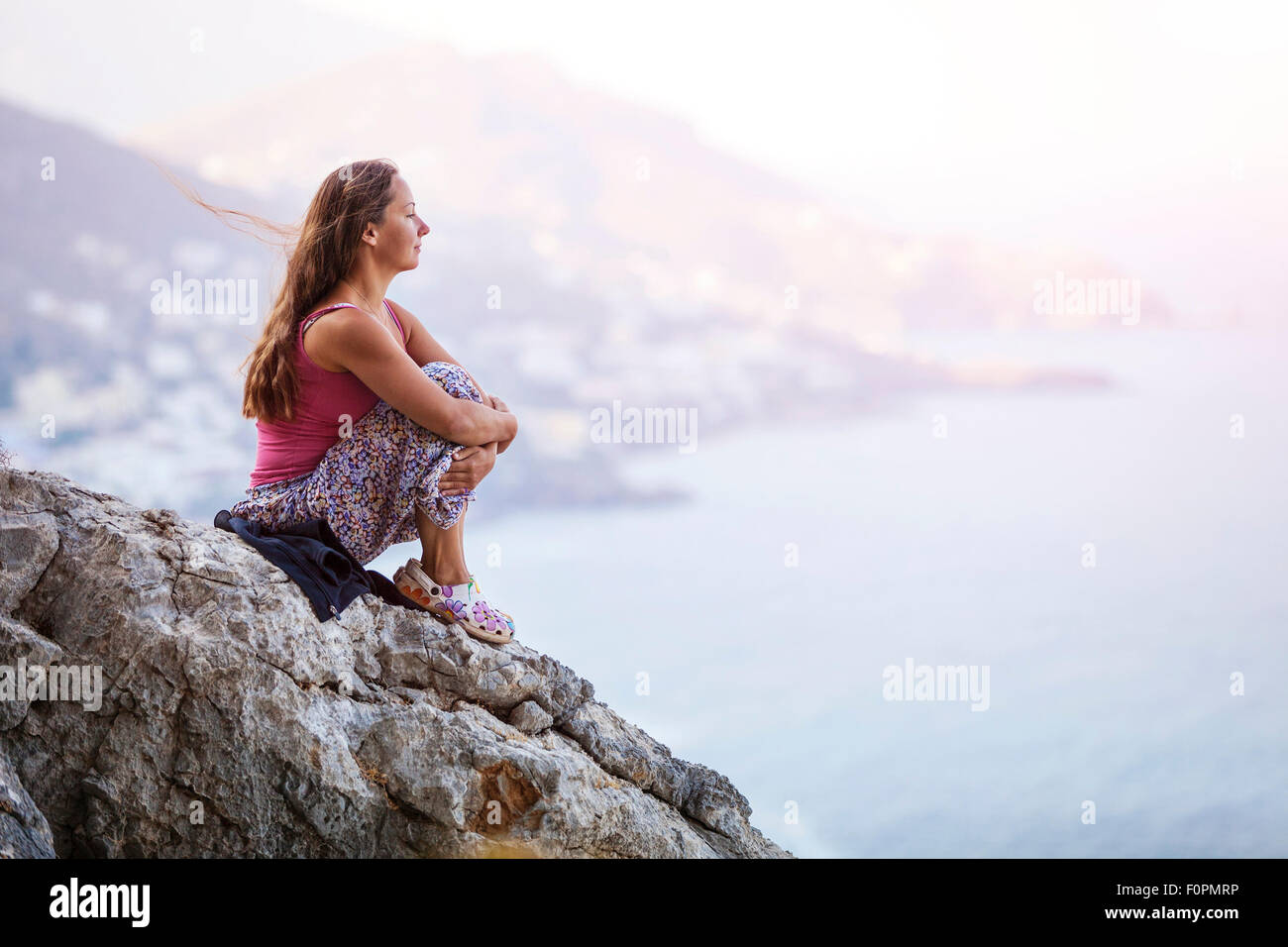 Girl sitting on edge cliff hi-res stock photography and images - Alamy