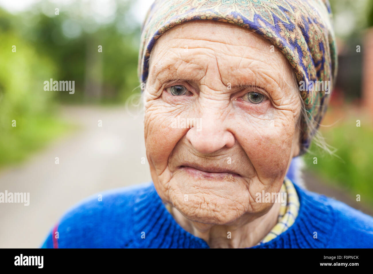 Portrait of an aged woman smiling outdoors Stock Photo - Alamy