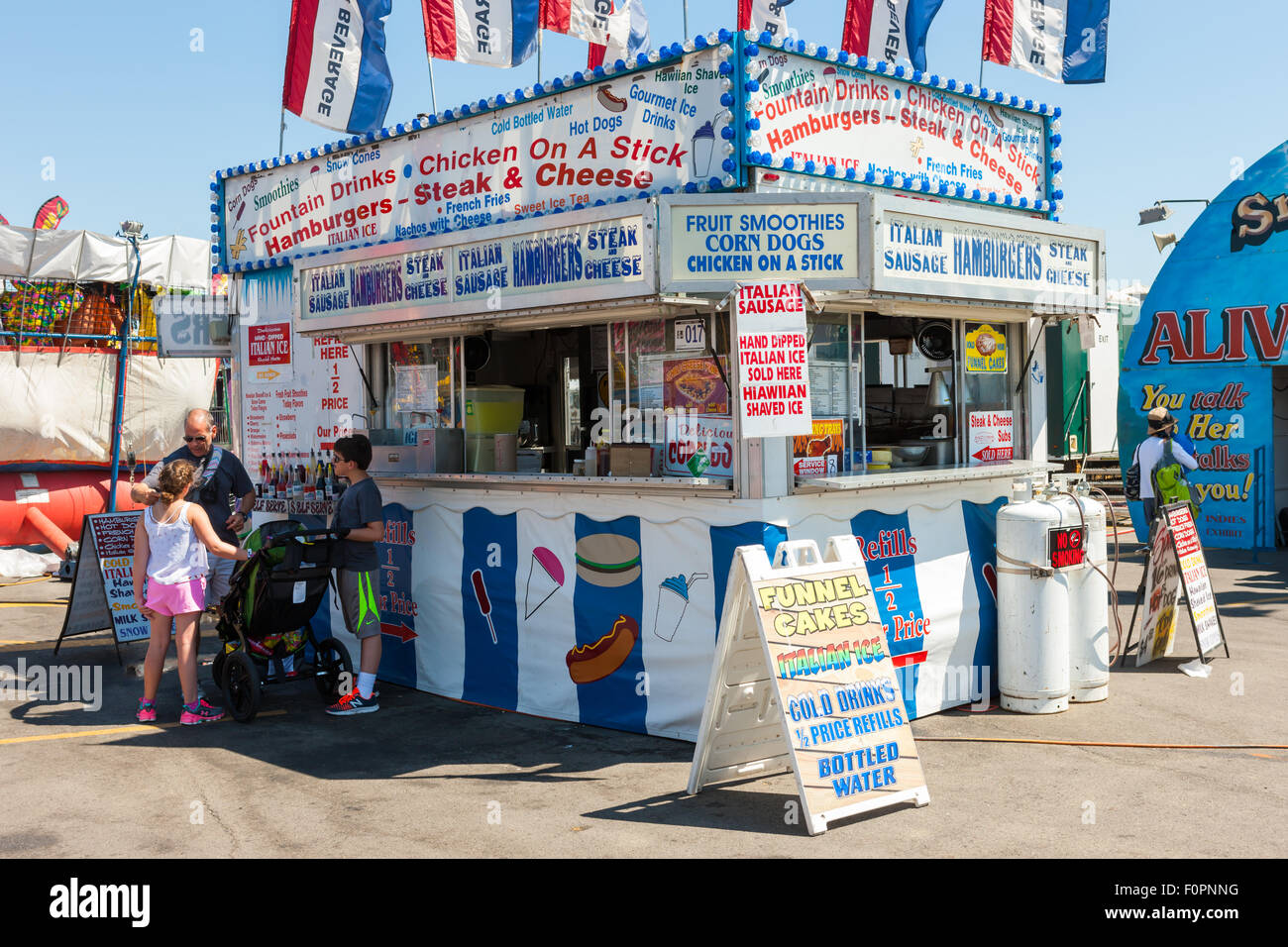 A family stops at a food concession selling various snacks at the Ohio State Fair in Columbus, Ohio. Stock Photo