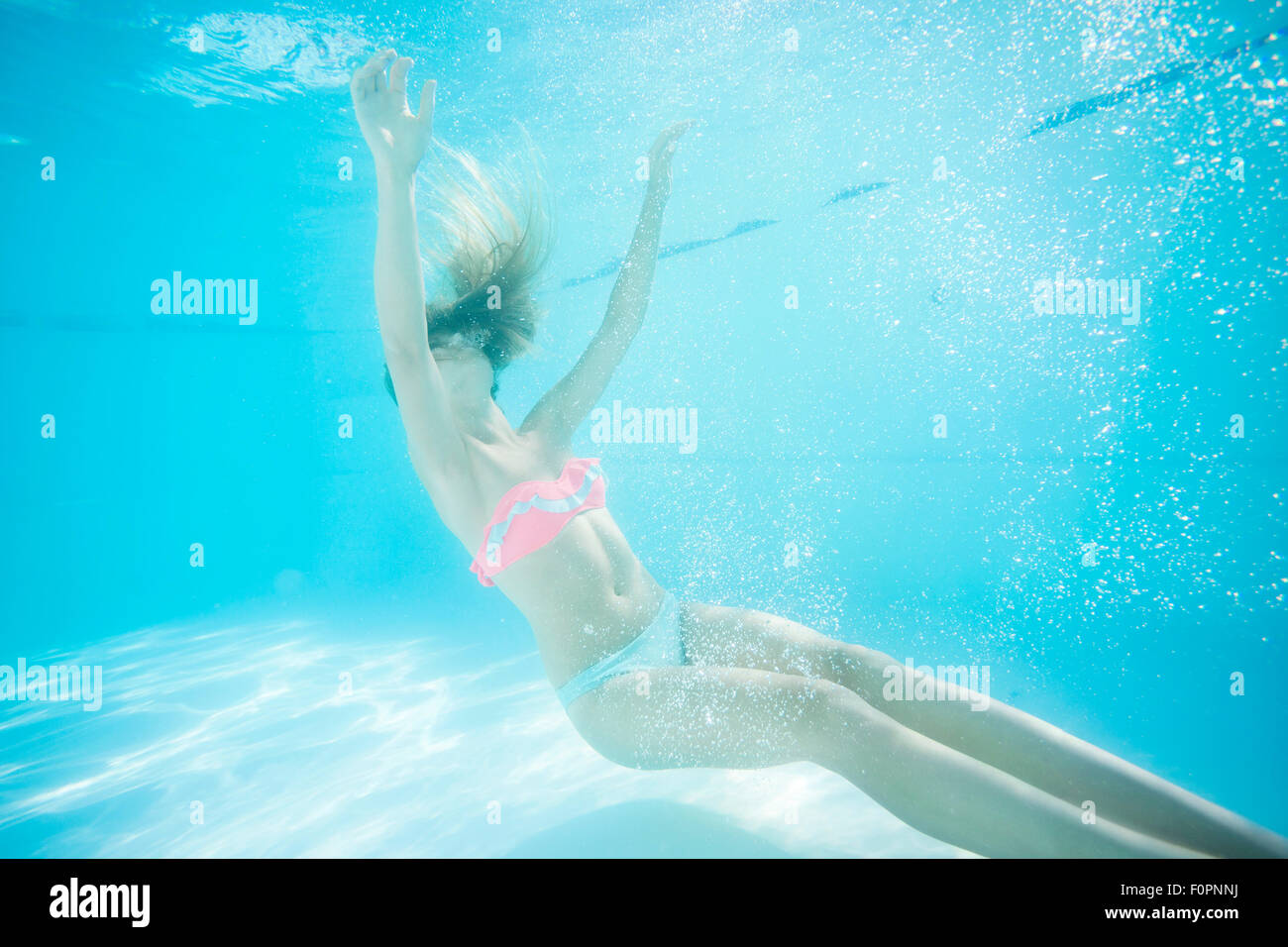 Young woman underwater in swimming pool. Danger of accidental Stock Photo