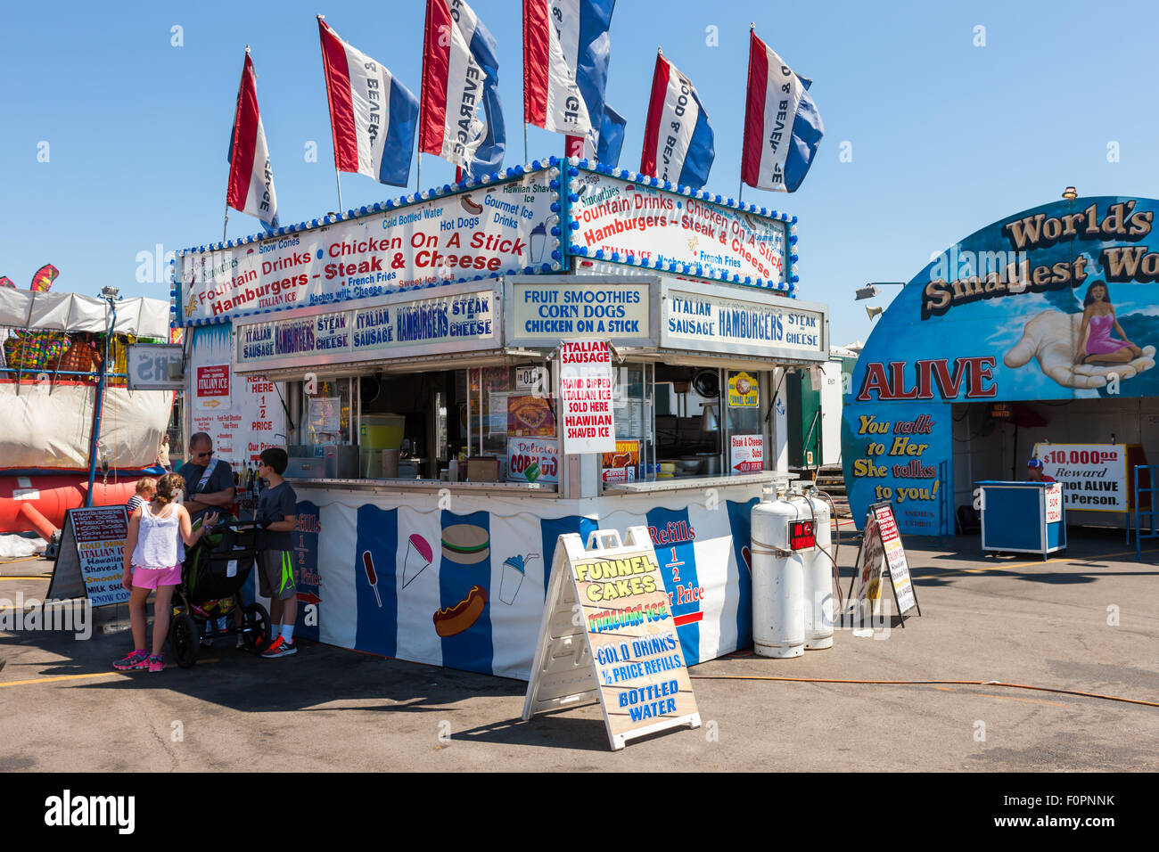 A family stops at a food concession selling various snacks at the Ohio State Fair in Columbus, Ohio. Stock Photo