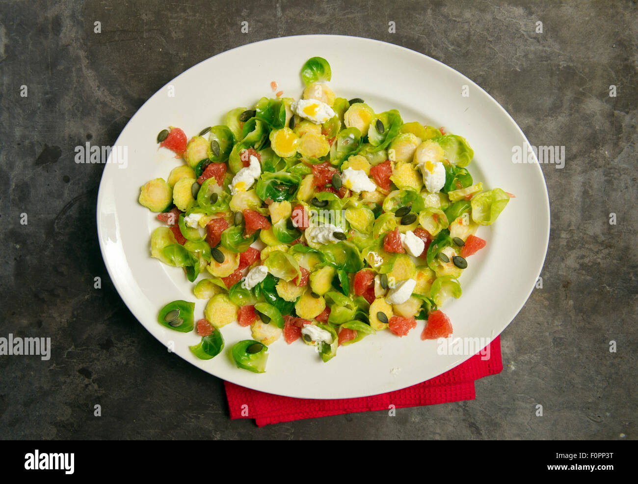 Brussels sprout salad with grapefruit and ricotta. Stock Photo