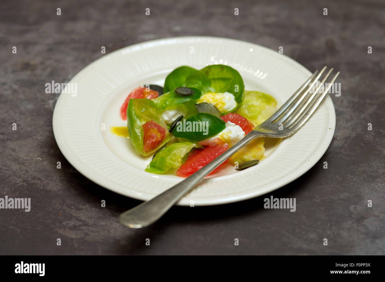 Brussels sprout salad with grapefruit and ricotta. Stock Photo