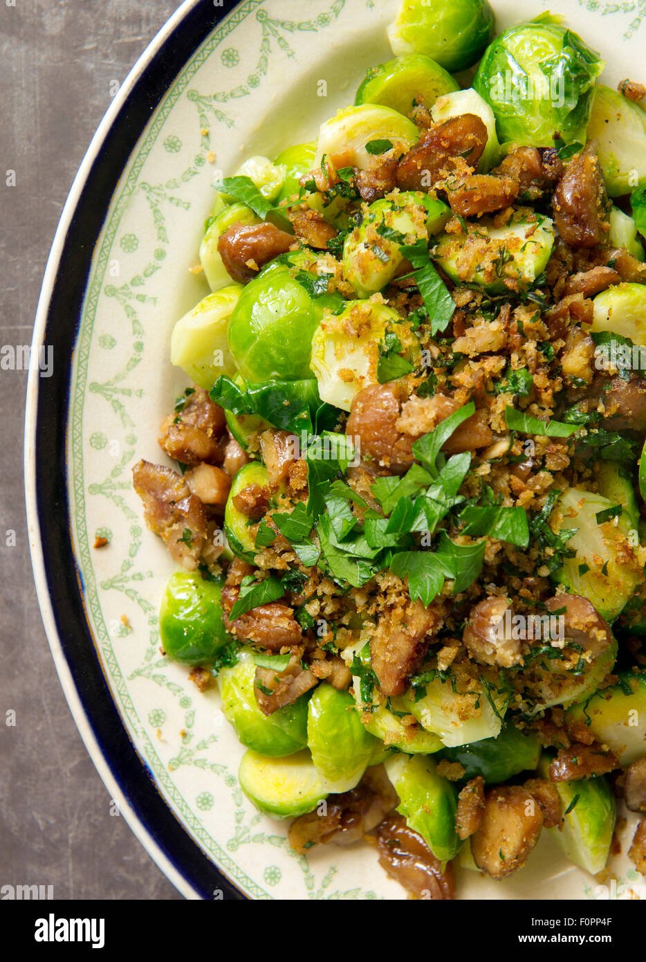 Brussels sprouts with lemon crumbs and chestnuts. Stock Photo