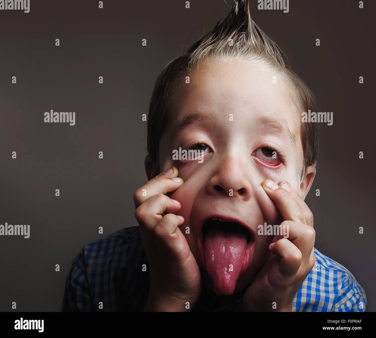 Playful little boy making funny faces Stock Photo Alamy