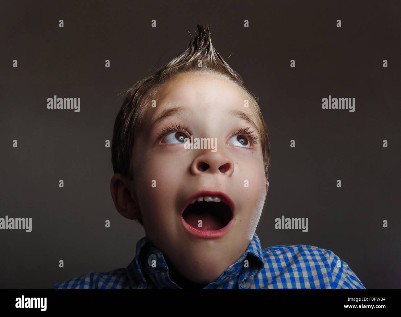 Low key portrait of cute boy looking surprised Stock Photo Alamy