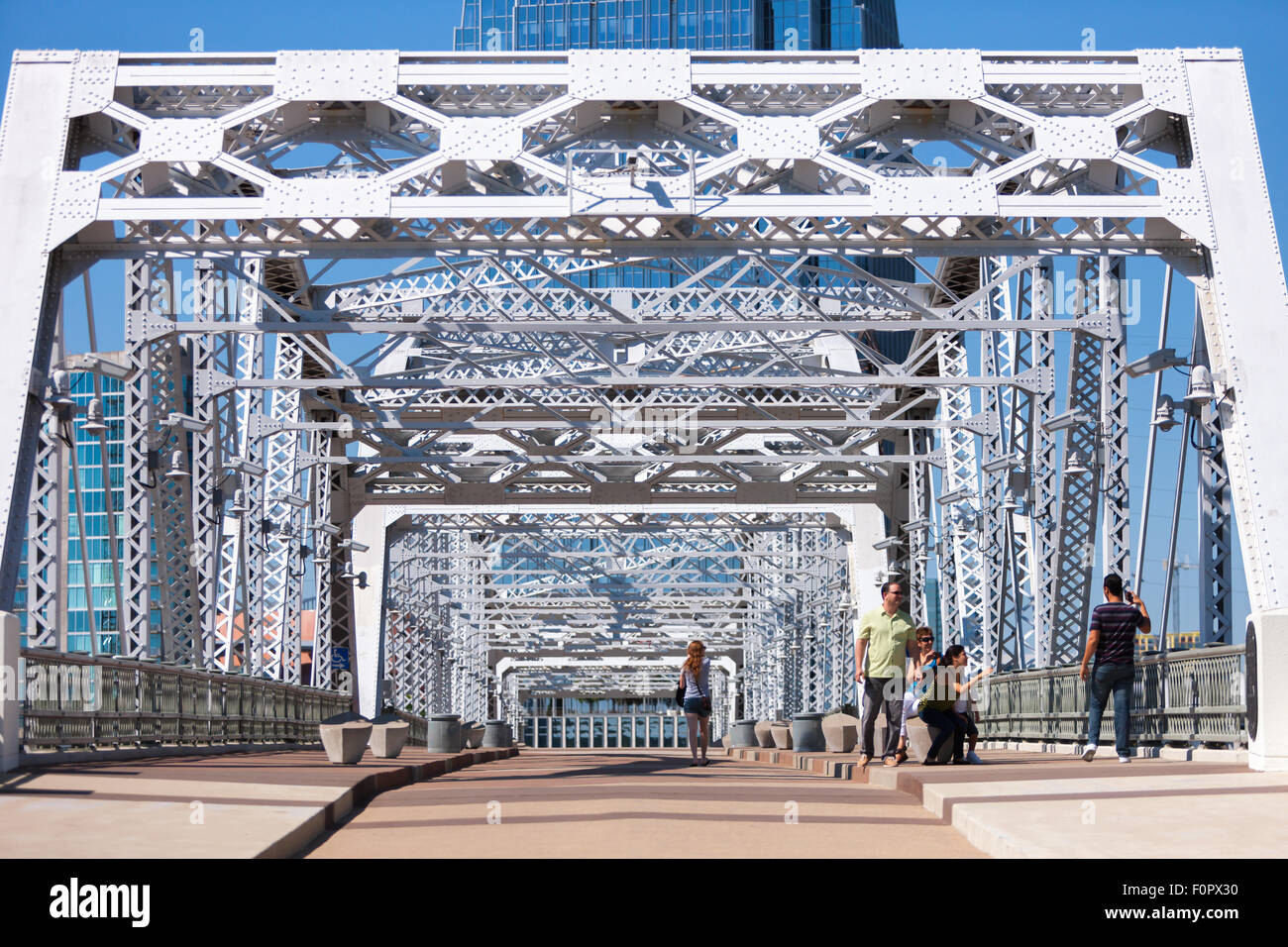 People stop and enjoy the view from the John Seigenthaler pedestrian bridge in downtown Nashville, Tennessee. Stock Photo