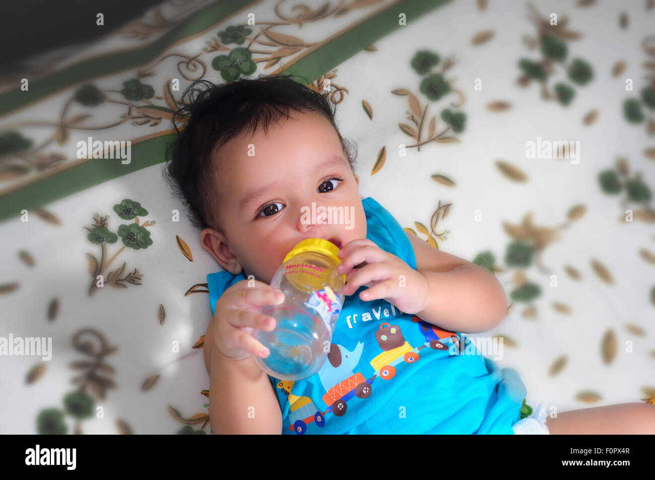 Close up portraits of a cute, beautiful Bengali baby boy with bottle in ...