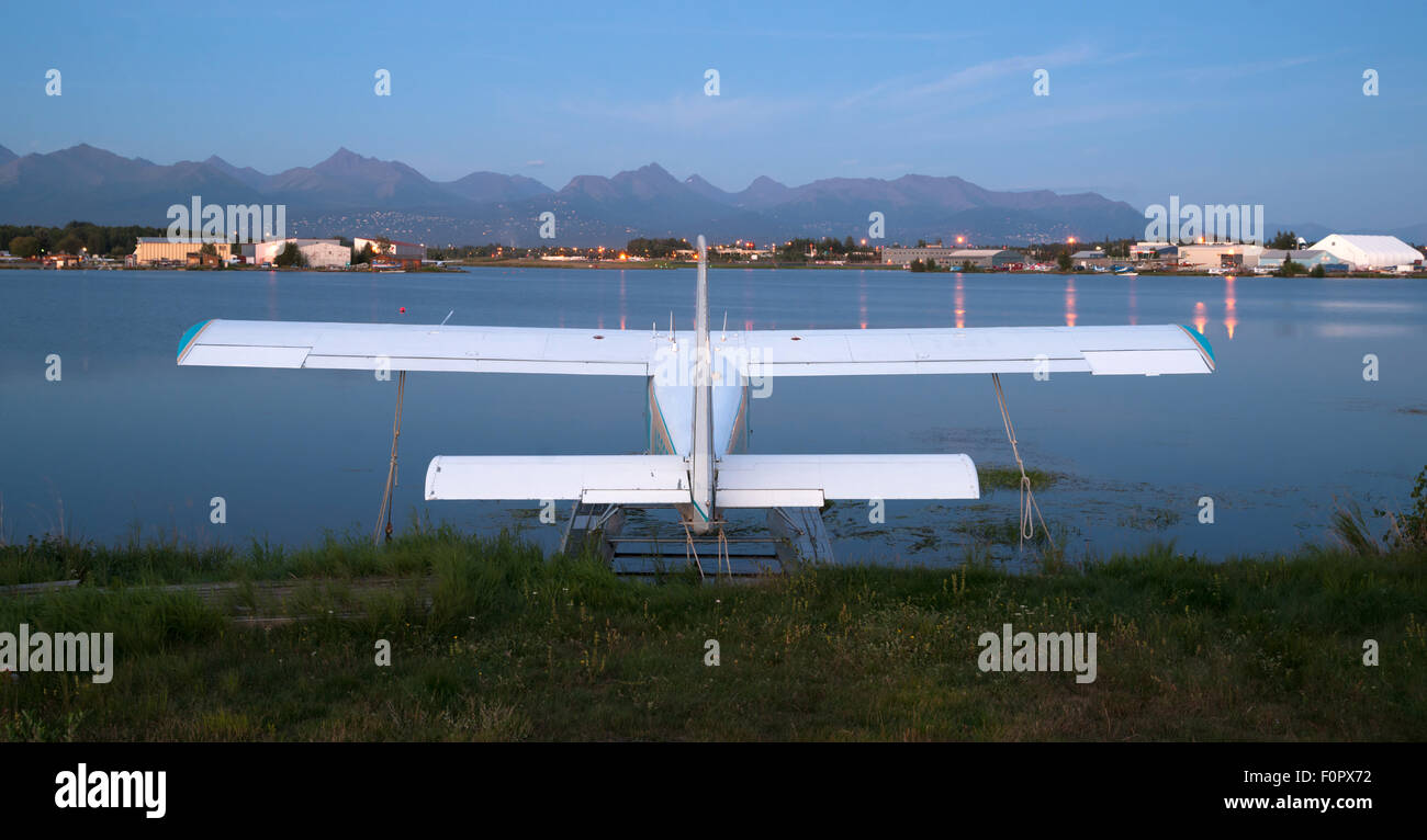 A plane sits waiting for the next chance to be of service as darkness falls on Anchorage Stock Photo