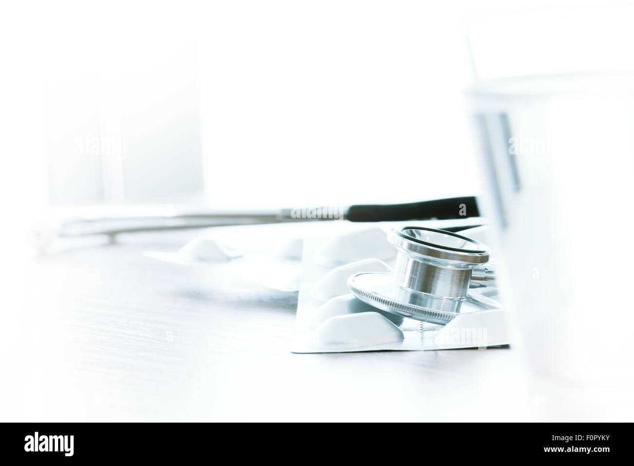 Studio macro of a stethoscope and digital tablet abstract on wood table ...