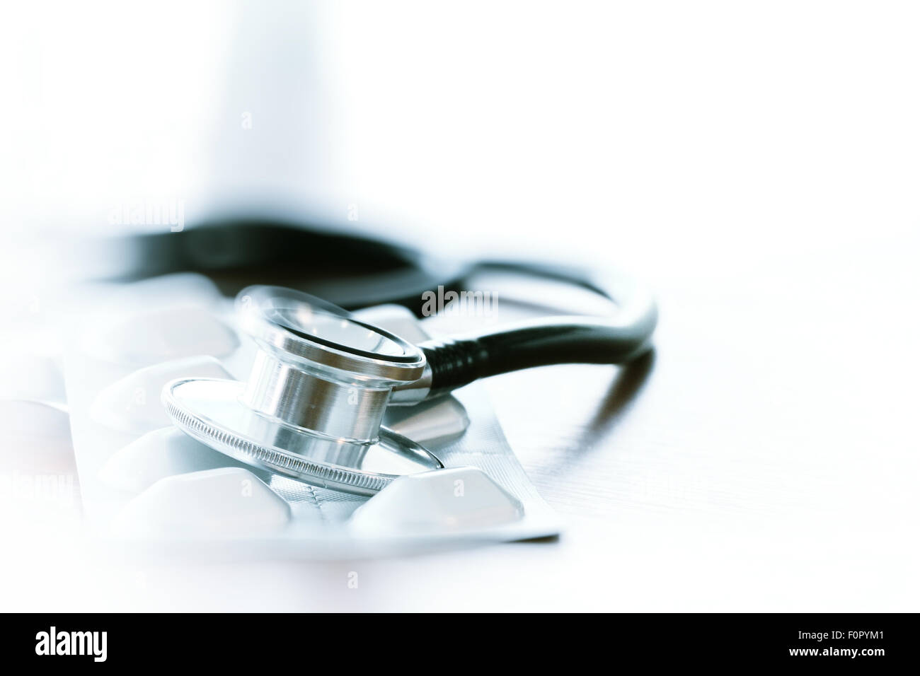 Studio macro of a stethoscope and digital tablet abstract on wood table ...