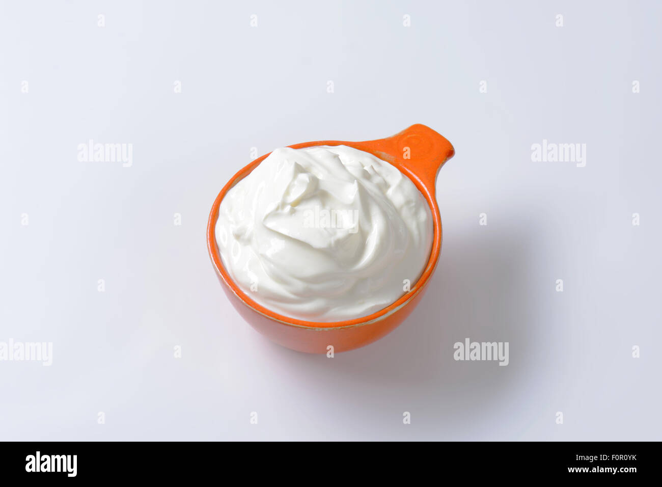 creme fraiche in an orange bowl Stock Photo
