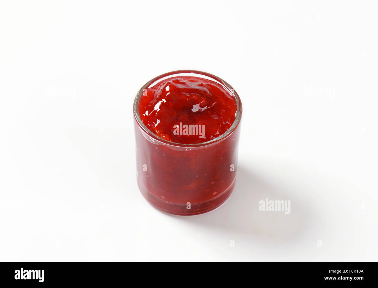 glass of strawberry jam on white background Stock Photo