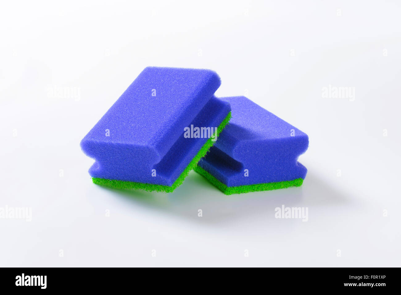 two blue kitchen sponges on white background Stock Photo Alamy