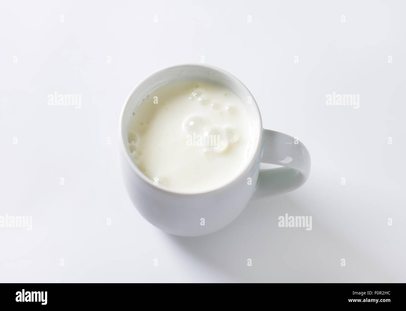 mug of milk kefir on white background Stock Photo