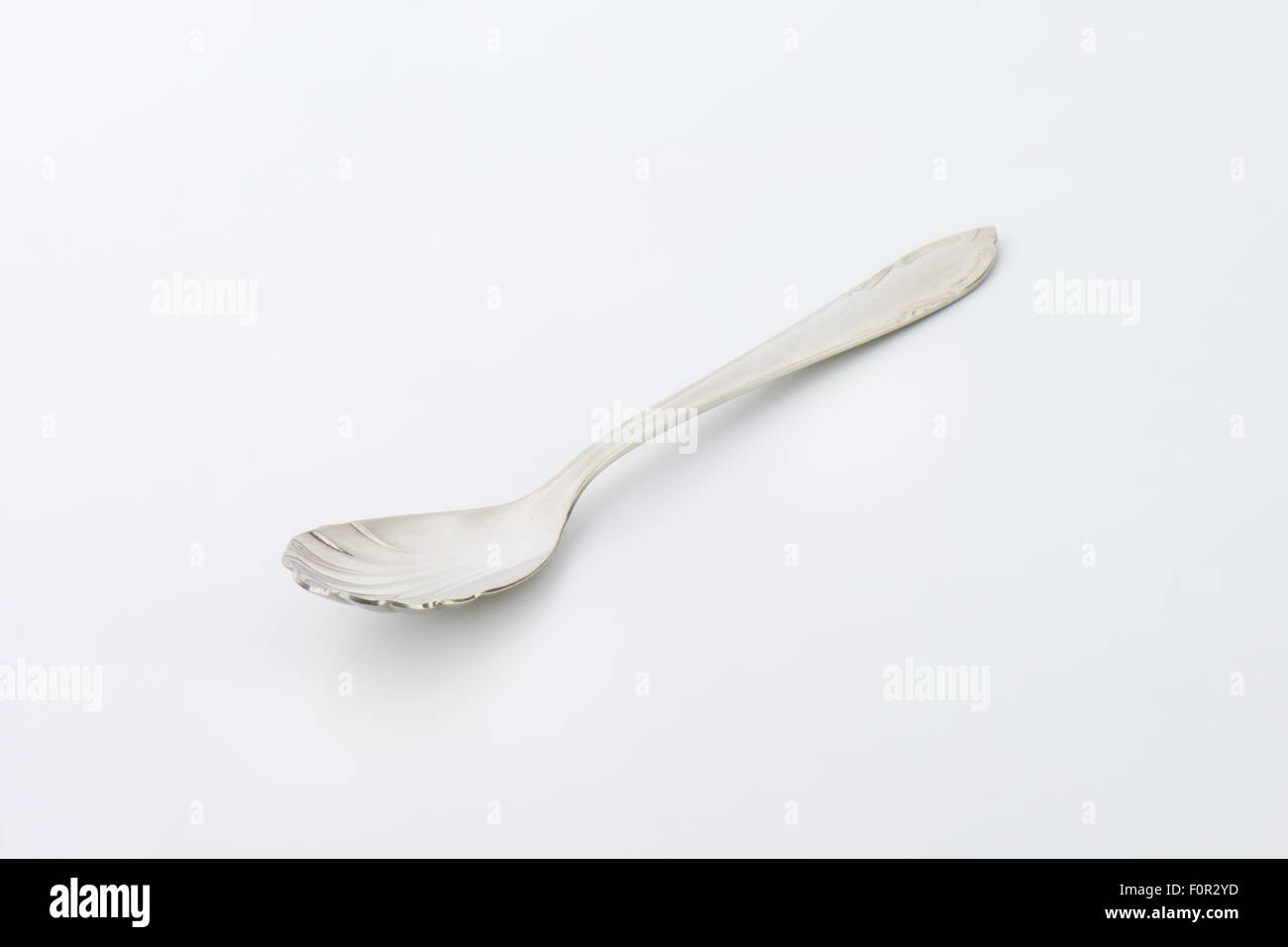 Cheese spoon with finely decorated cup and handle Stock Photo