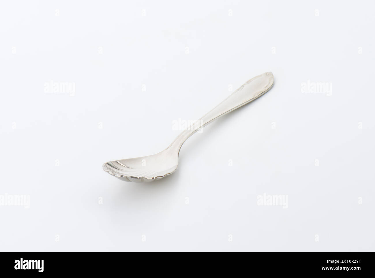 Cheese spoon with finely decorated cup and handle Stock Photo