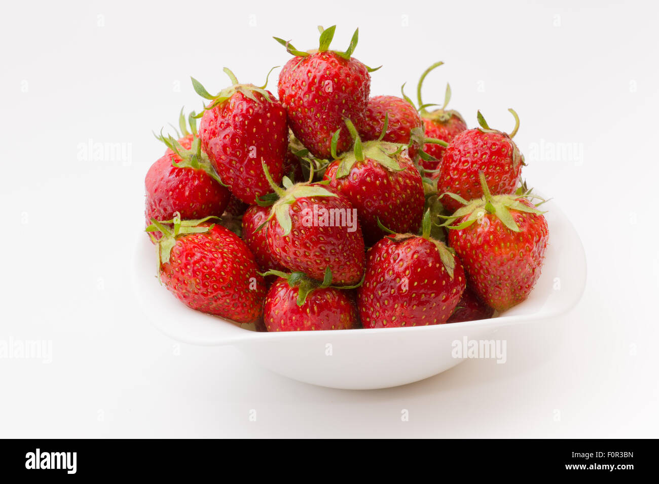 bowl full of ripe juicy strawberry on a white background Stock Photo ...