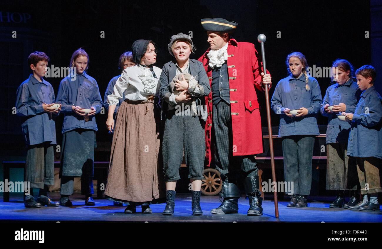 Hamburg, Germany. 19th Aug, 2015. Actresses Alexandra Kurzeja (front row l-r), Carolin Waltsgott as 'Oliver Twist' and actor Steve Alex perform on stage during the photo rehearsal for the family musical 'Oliver Twist' in Hamburg, Germany, 19 August 2015. The musical premieres on 22 August 2015 in the Harburger theatre. Photo: Markus Scholz/dpa/Alamy Live News Stock Photo