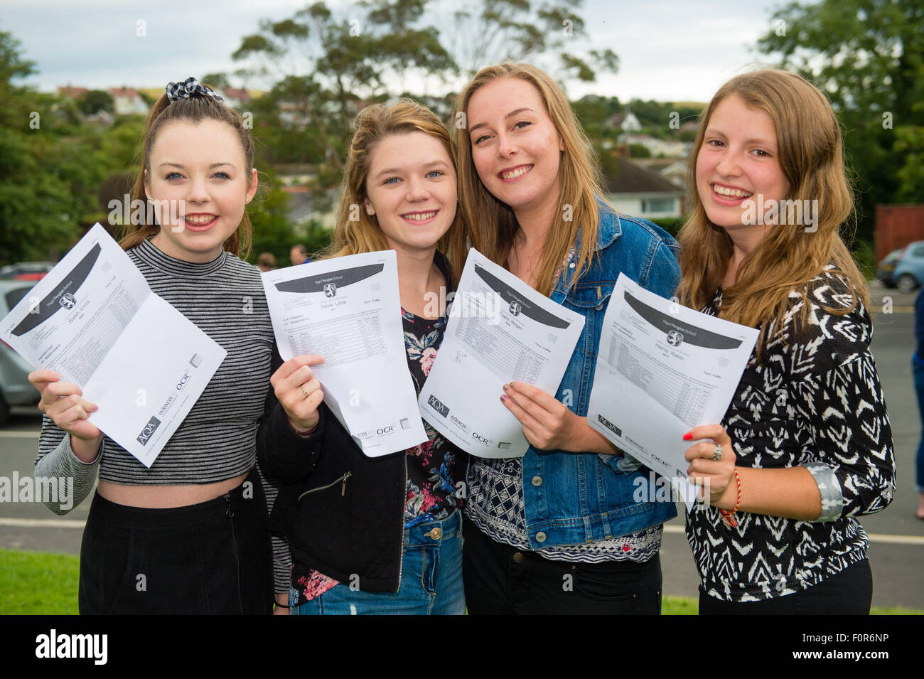 Aberystwyth Wales UK, Thursday 20 August 2015   Four 4 Year 11 teenage girls students Emily Walsh, Lorna Harper, Megan Evans and Robin Harris at Penglais School in Aberystwyth collecting their GCSE examination results. Across the UK GCSE grades A* to C have risen slightly this year, but top A* and A grades are marginally lower. Overall the proportion of A* to C grades rose to 69%, up from 68.8% in 2014, but A* grades fell by 0.1% photo Credit:  Keith Morris/Alamy Live News Stock Photo
