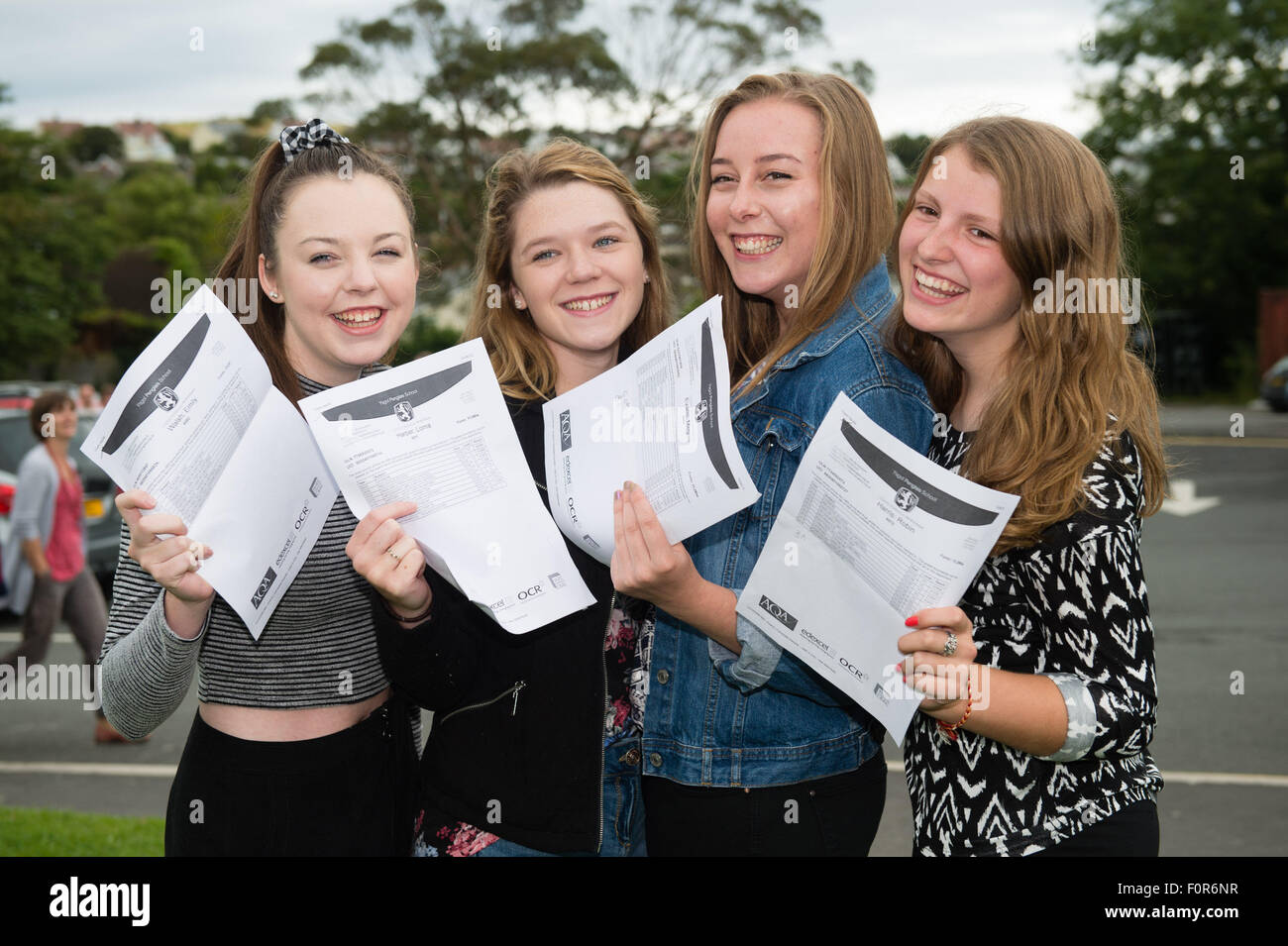 Aberystwyth Wales UK, Thursday 20 August 2015   Four 4 Year 11 teenage girls students Emily Walsh, Lorna Harper, Megan Evans and Robin Harris at Penglais School in Aberystwyth collecting their GCSE examination results. Across the UK GCSE grades A* to C have risen slightly this year, but top A* and A grades are marginally lower. Overall the proportion of A* to C grades rose to 69%, up from 68.8% in 2014, but A* grades fell by 0.1% photo Credit:  Keith Morris/Alamy Live News Stock Photo