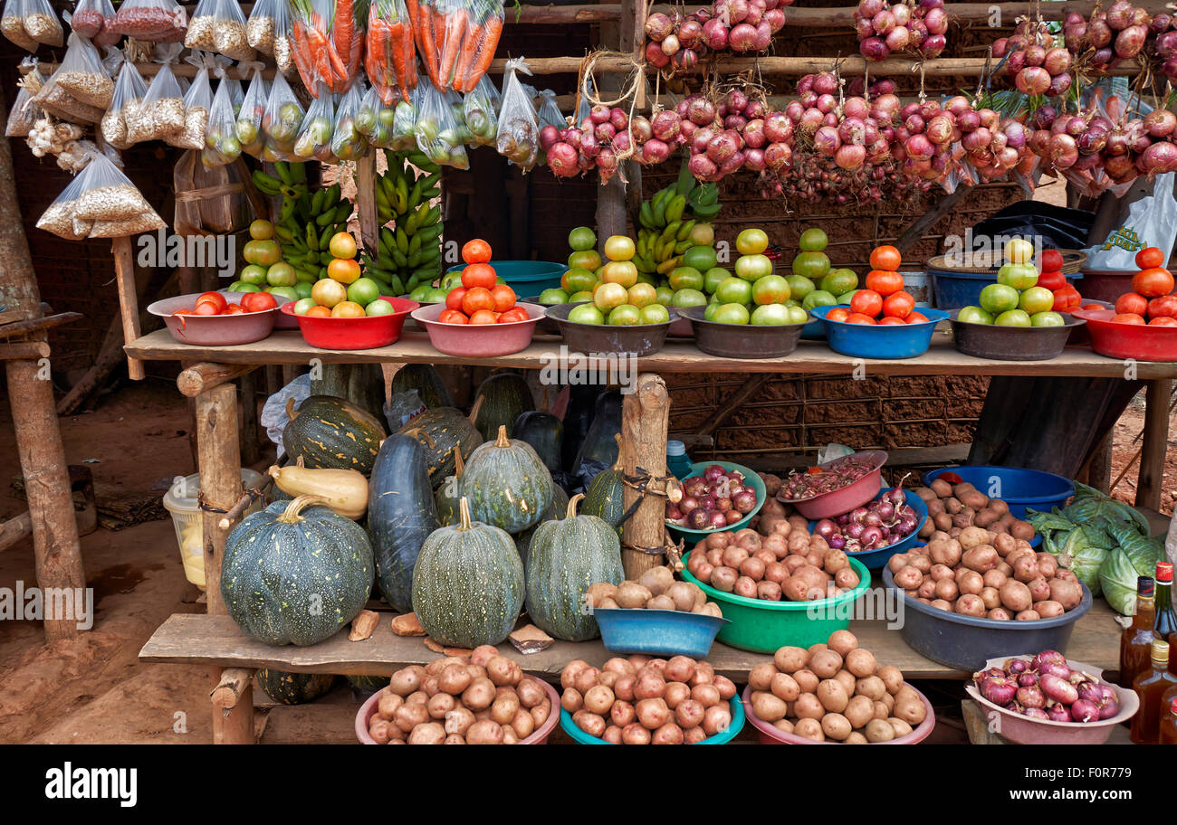 market stalls with fruits and vegetables beneath the road, Uganda