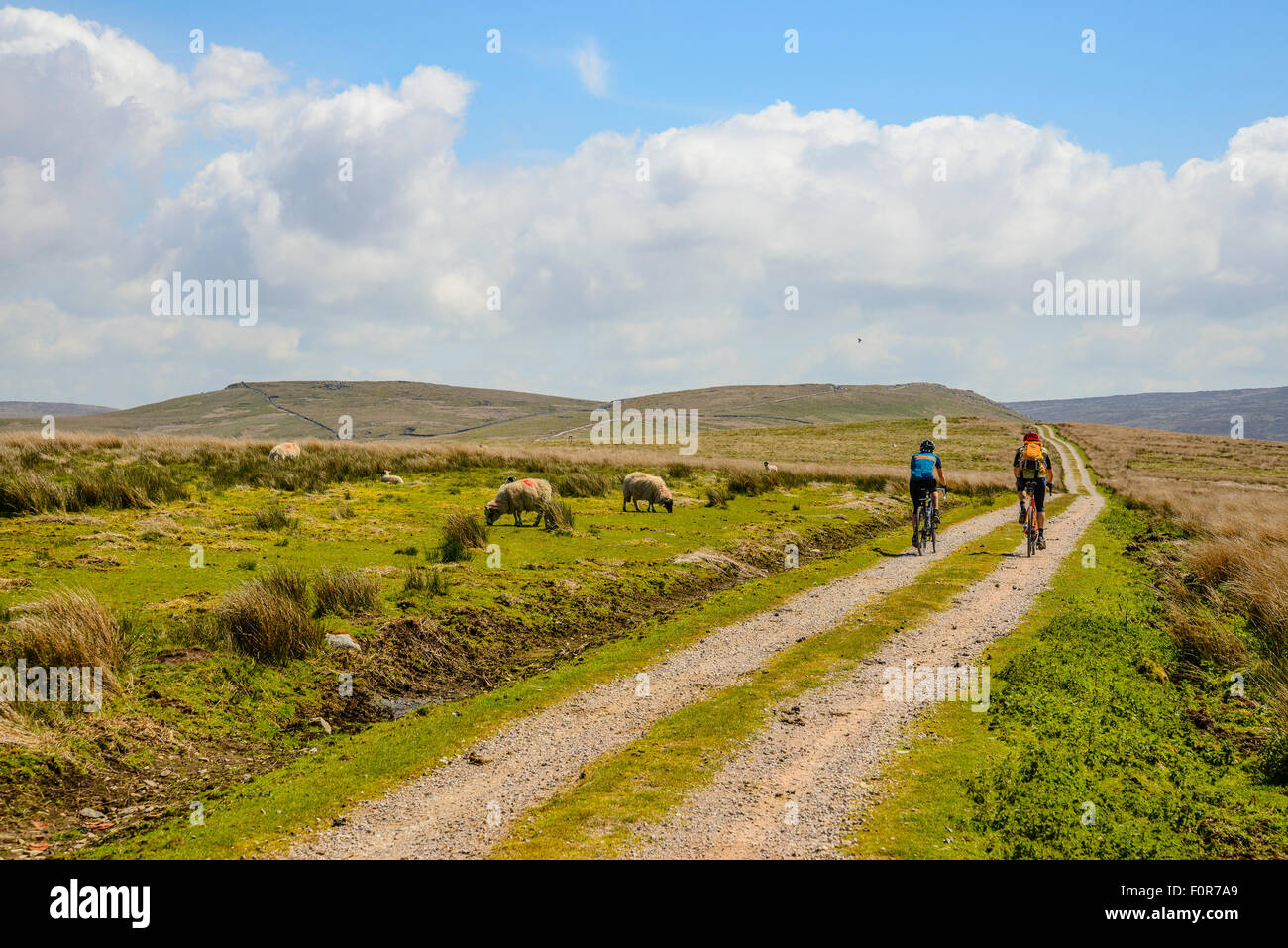 Two cyclists on a track across the Bowland Fells Lancashire variously known as Salter’s Way Salter Fell Road or Hornby Road Stock Photo